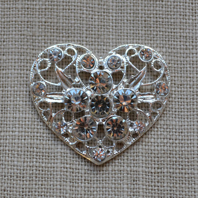 Great Vintage Large Heart Rhinestone Embellishment (Holly) for DIY Wedding.Large Heart Rhinestone embellishments - Elegant and delicate filigree moulding with a central diamante rhinestone flower culster. Perfect for all Wedding stationery, will look lovely on wedding shoes, wedding cakes and special craft projects. These high quality luxury Grade A embellishments have stunning diamantes that are crystal clear and refract the light beautifully to produce a stunning sparkle.
Size: 33mm x 30mm , 6mm thick, without pin on back Cheap Vintage Wedding Large Heart Rhinestone Embellishment (Holly) | Diamante Embellishments